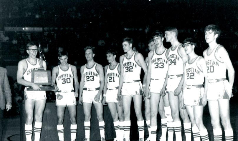 male basketball athletes receiving trophy