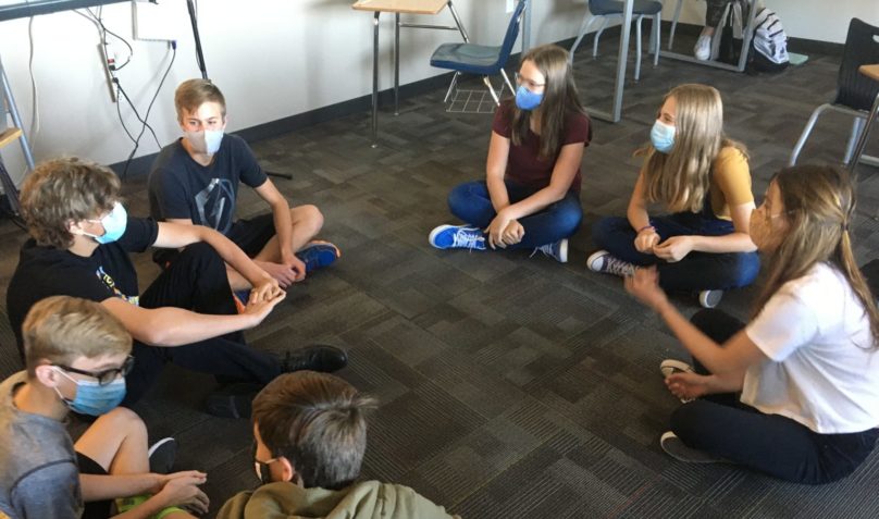group of students sitting on the floor