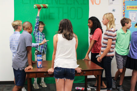 group of middle school students around a table
